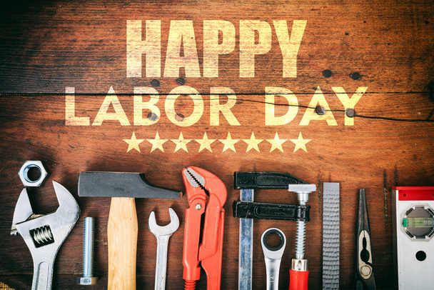Happy Labor Day text and construction tools on wooden table, top view. United States America holiday celebration - Foto, immagini