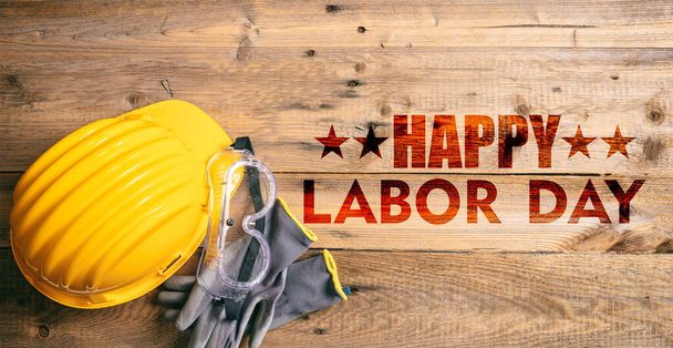 Happy Labor Day text and construction tools on wooden table, top view. United States America holiday celebration - Fotoğraf, Görsel