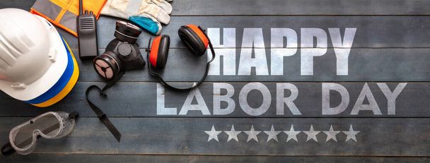 Happy Labor Day text and construction tools on wooden table, top view. United States America holiday celebration, banner - Fotoğraf, Görsel