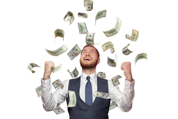Счастливый успешный человек, стоящий под денежным дождем изолированы на белом фоне - Фото, изображение