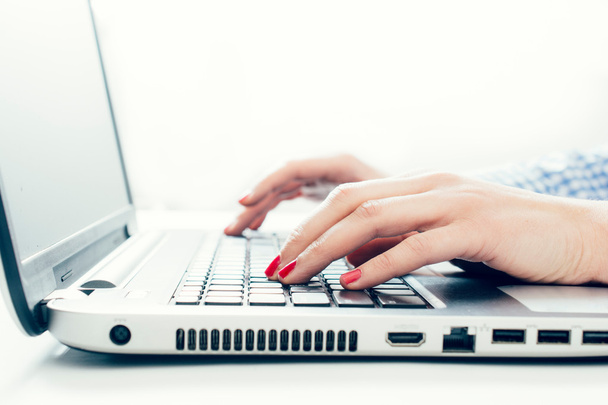 Woman using laptop computer and typing - Photo, Image