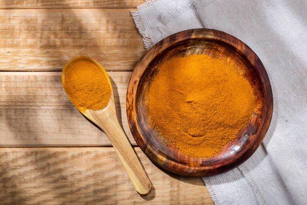 Turmeric powder in bowl on the table, top view. - Photo, Image