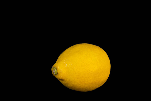 lemon on the black background. High quality photo - Φωτογραφία, εικόνα