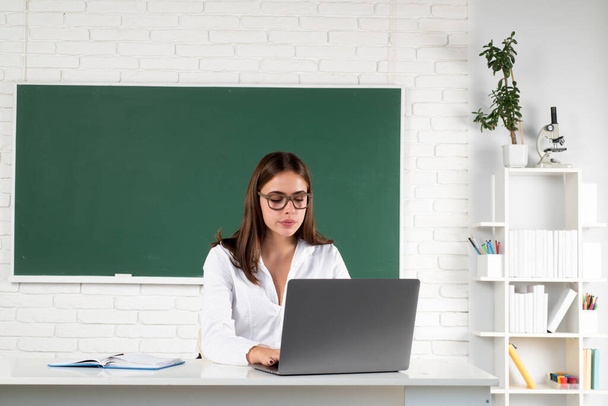 Female student with laptop computer on lesson lecture in classroom at high school or college. Online learning at school, distance education - Φωτογραφία, εικόνα