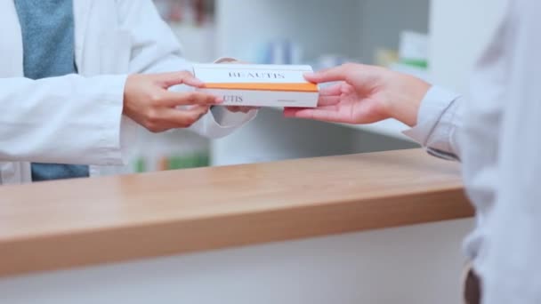 Pharmacist giving prescription medication, pills or medicine to customer inside a pharmacy, clinic or drug store. Medical professional or pharmaceutical giving a patient antibiotics product closeup. - Filmmaterial, Video