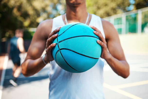 Just dunk it. Closeup shot of a sporty man holding a basketball on a sports court - Foto, Imagen