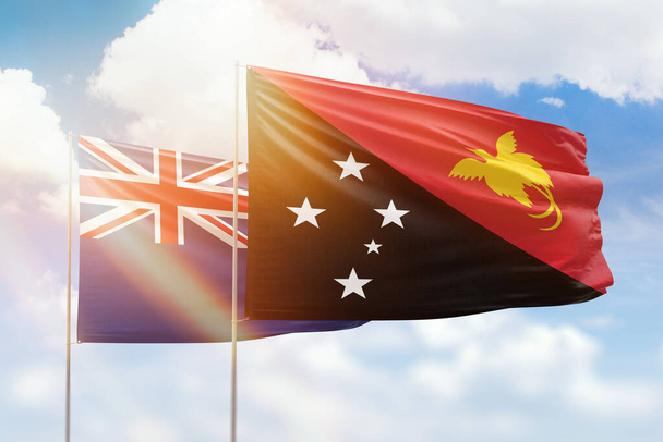 Sunny blue sky and flags of papua new guinea and new zealand - Zdjęcie, obraz