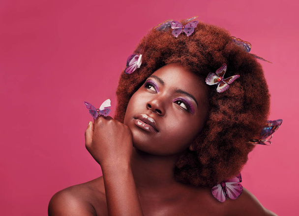 Should I make this my signature look. Studio shot of a beautiful young woman posing topless with butterflies in her hair against a purple background - Foto, afbeelding