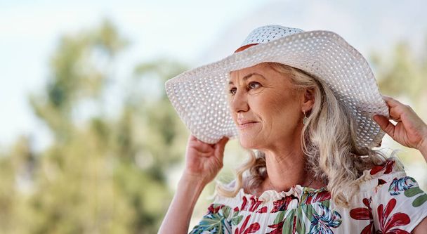 Owning her summer look. an attractive senior woman standing outdoors on a summers day - Photo, image