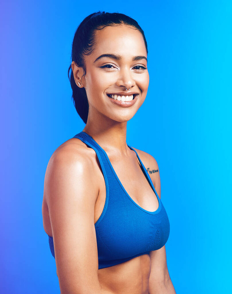 Im at my happiest when Im at my healthiest. Studio portrait of an attractive young sportswoman posing against a blue background - Foto, afbeelding