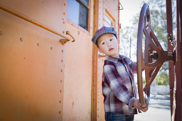 Cute Young Mixed Race Boy Having Fun on Railroad Car - Photo, Image