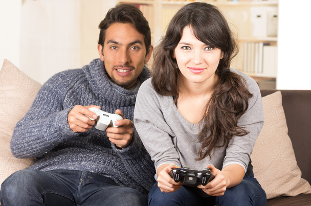 young cute couple playing video games - Foto, afbeelding