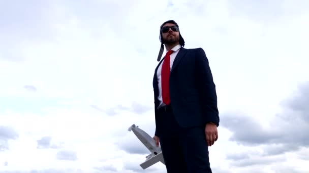 man in business suit and pilot hat with glasses hold plane, success. - Materiaali, video