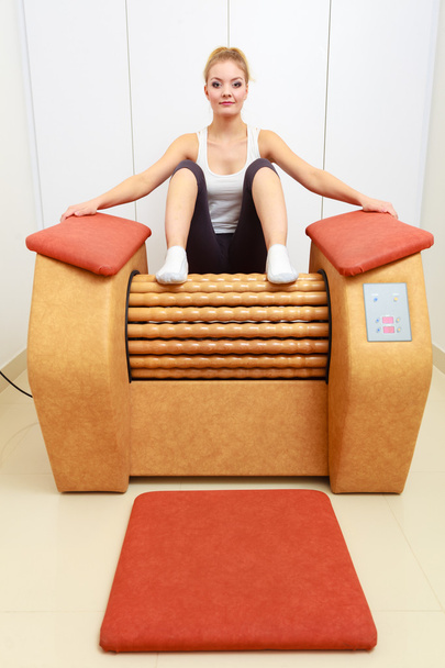 Girl relaxing on  massage equipment - Фото, изображение