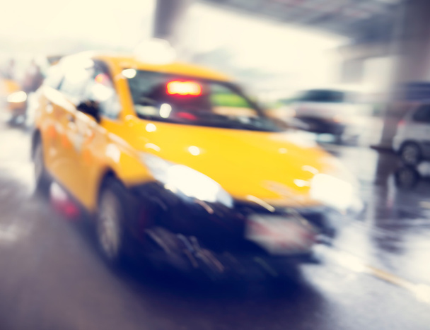 Taxi cab speeding past an airport terminus - Photo, Image
