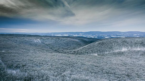 An aerial drone shot of the forested hills on a cloudy day - Photo, image