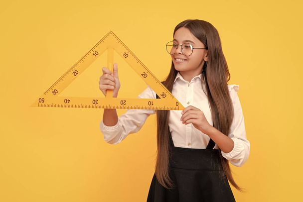 mathematics. happy teen girl hold triangle. back to school. algebra and geometry. kid glasses study math. angle degree measurement. trigonometry stationery. measuring and sizing. education for child. - Fotoğraf, Görsel