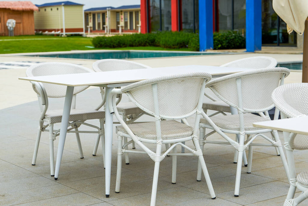 White table and chair arrangement for outdoor tent party - Fotó, kép