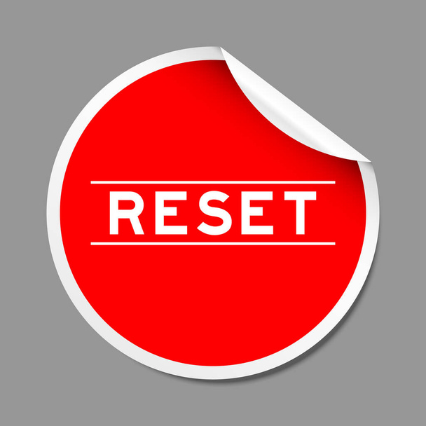 Red color peel sticker label with word reset on gray background - Vektori, kuva