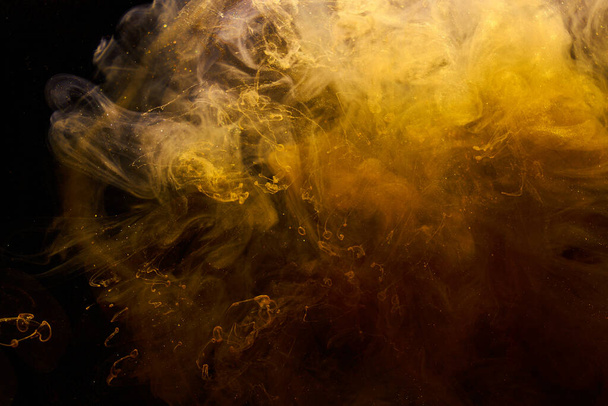 Liquid fluid art abstract background. Ocher jets and smoke rings dancing acrylic paints underwater, space ocean, color explosion - 写真・画像