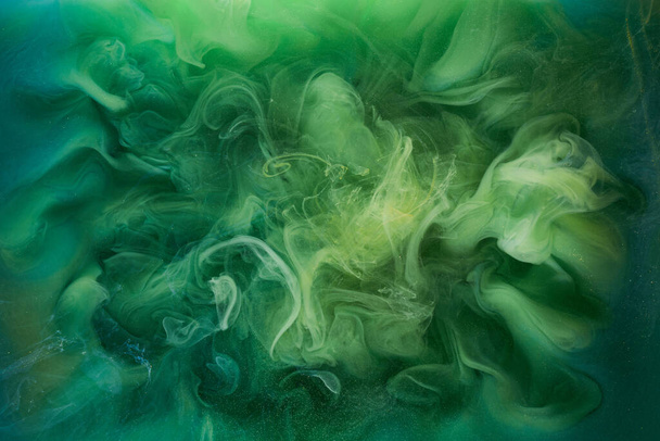 Liquid fluid art abstract background. Green dancing acrylic paints underwater, cosmic smoke ocean - Фото, зображення