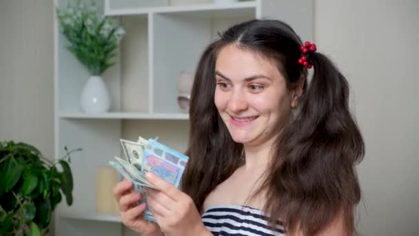 A cheerful funny woman counts the money and rejoices. - Footage, Video