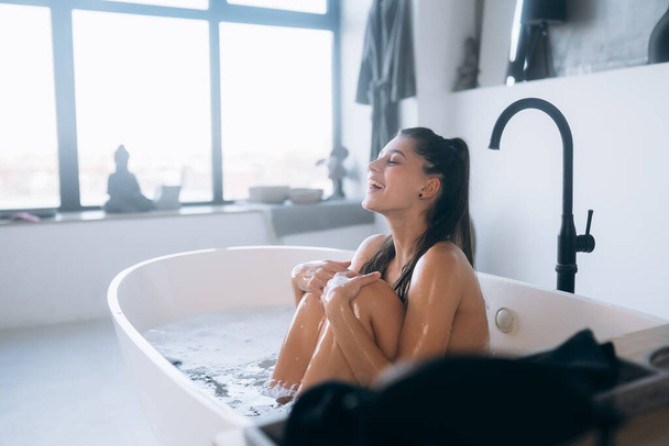 Pretty young woman taking bath at home - 写真・画像
