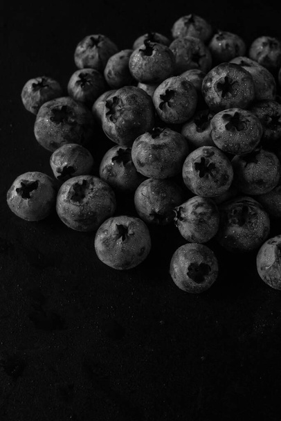 Handful of blueberries on black background. Handful of blueberries Ripe berries. Healthy Lifestyle. Useful products. Lots of vitamins. - Zdjęcie, obraz