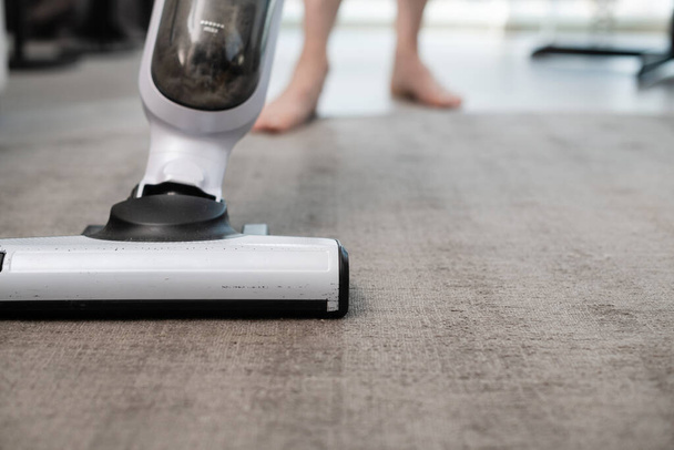 Home cleaning in the apartment with a vacuum cleaner. Carpet cleaning with a vacuum cleaner. - Photo, Image
