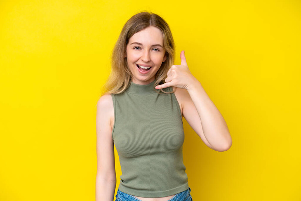 Blonde English young girl isolated on yellow background making phone gesture. Call me back sign - Foto, afbeelding