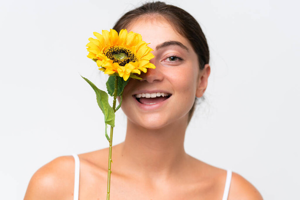 Young Pretty caucasian woman isolated on white background holding a sunflower while smiling. Close up portrait - Foto, immagini