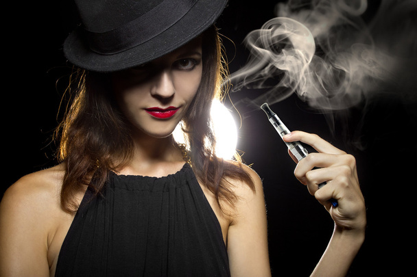 Woman vaping an electronic cigarette - Valokuva, kuva