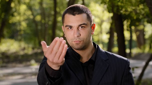 Caucasian businessman with strong serious eyesight adult confident man wear formal black suit pointing finger at camera hey you come here inviting hand gesture welcome symbol calling to show something - Foto, immagini