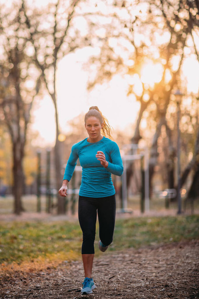 Woman Jogging Outdoors in the Park - Photo, image