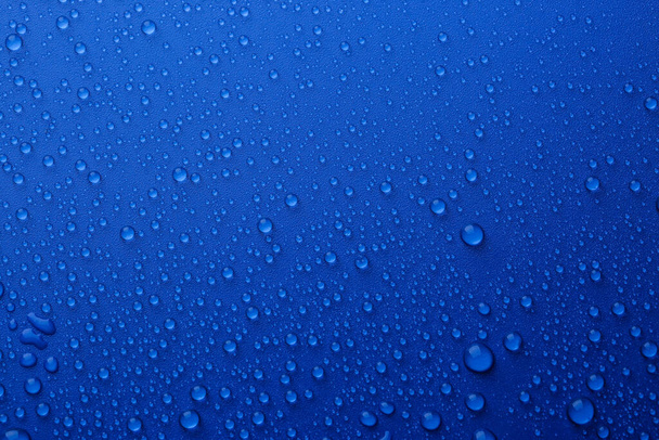 Water drops on blue background, top view - Photo, Image