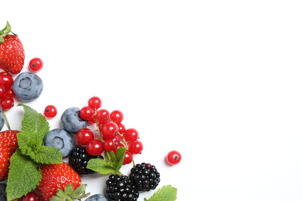 Mix of fresh berries on white background, flat lay - Foto, afbeelding