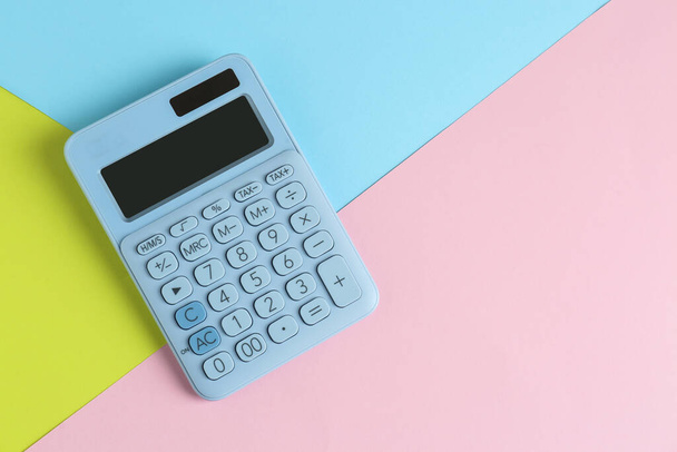 Modern calculator on color background, top view. Space for text - Foto, Imagen