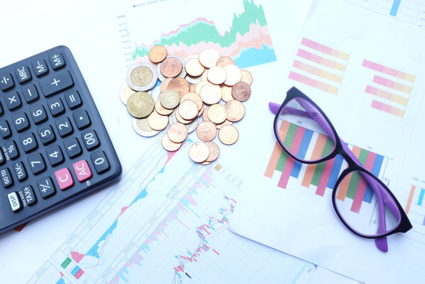 flat lay a glasses, money, calculator and chart or graph on office desk table.Finance and business concept.  - Photo, Image