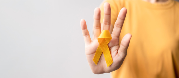 Yellow September, Suicide prevention day, Childhood, Sarcoma, bone and bladder cancer Awareness month, Yellow Ribbon for supporting people life and illness. Healthcare and World cancer day concept - 写真・画像