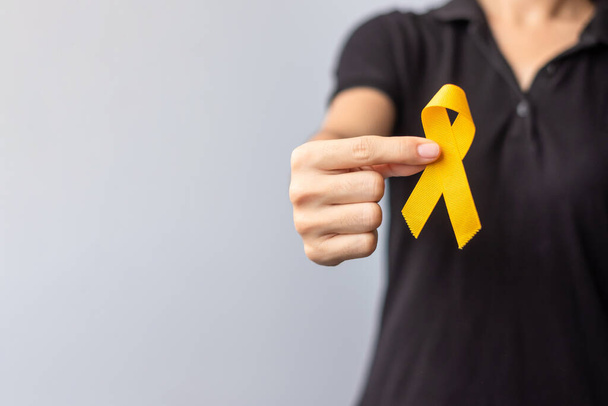Suicide prevention day, Childhood, Sarcoma, bone and bladder cancer Awareness month, Yellow Ribbon for supporting people life and illness. children Healthcare and World cancer day concept - Foto, Imagen