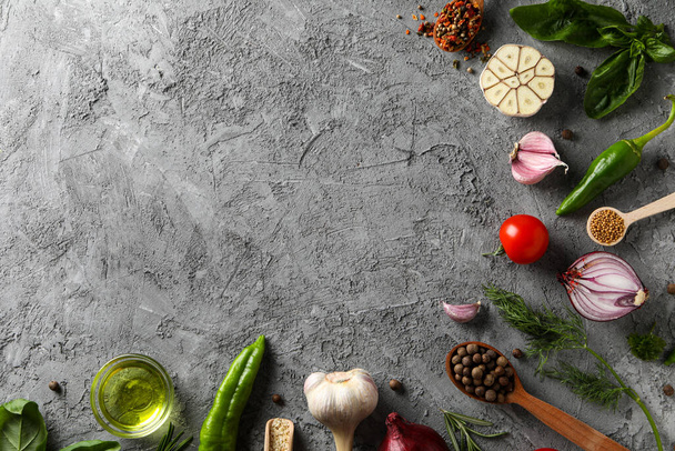 Different ingredients for cooking on gray textured background - Foto, Bild