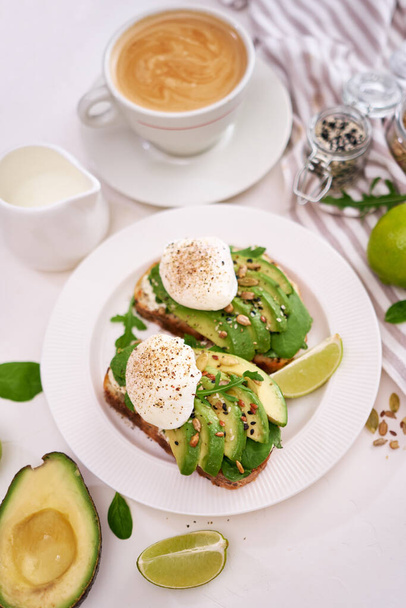 Freshly made poached egg and Avocado toasts on light grey background. - Foto, immagini