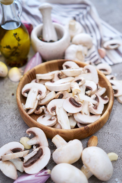 champignon mushrooms in wooden bowl at domestic kitchen. - Φωτογραφία, εικόνα