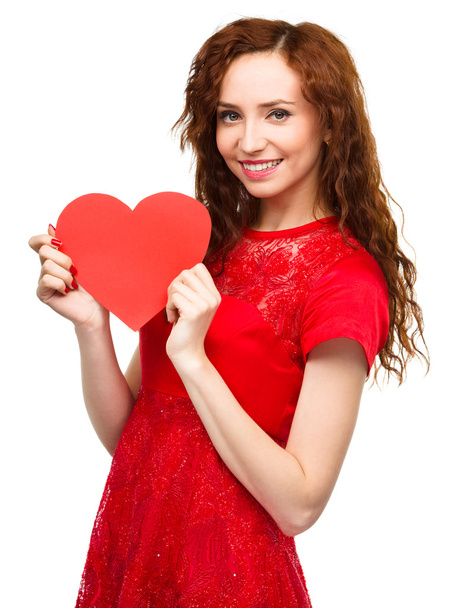 Young woman holding red heart - 写真・画像