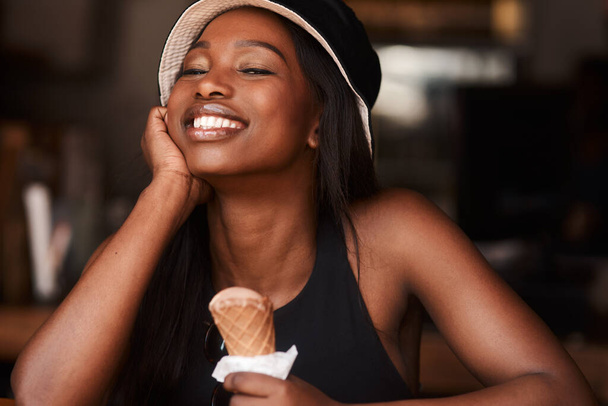 Ice cream takes me back to the good old days. a happy young woman in a cafe - Photo, Image
