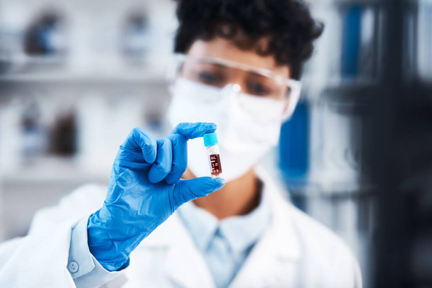 Working hard to create a cure thatll save many lives. Closeup shot of a young scientist working with samples in a lab - Foto, afbeelding