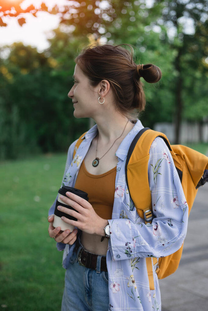 urban lifestyle - girl with coffee and backpack on city stree - Φωτογραφία, εικόνα
