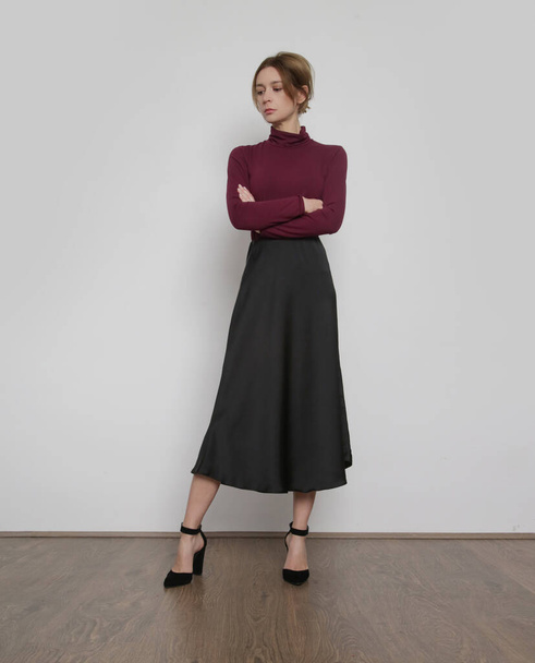 Serie of studio photos of young female model wearing purple turtleneck with simple midi skirt. Comfortable and elegant everyday fashion. - Zdjęcie, obraz
