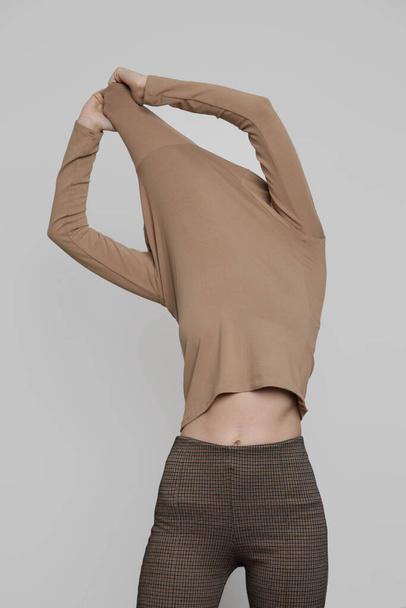 Serie of studio photos of young female model wearing beige turtleneck made from organic cotton. Comfortable sustainable fashion. - Fotoğraf, Görsel