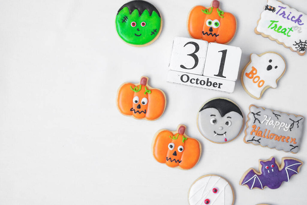Halloween funny Cookies with 31 October calendar on white background. Trick or Threat, Happy Halloween, Hello October, fall autumn, Festive, party and holiday concept - Photo, Image
